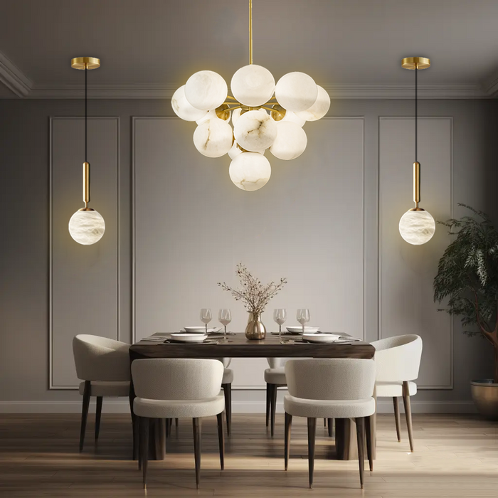 Display view of Aelios Chandelier in a modern dining room, hanging above the table.