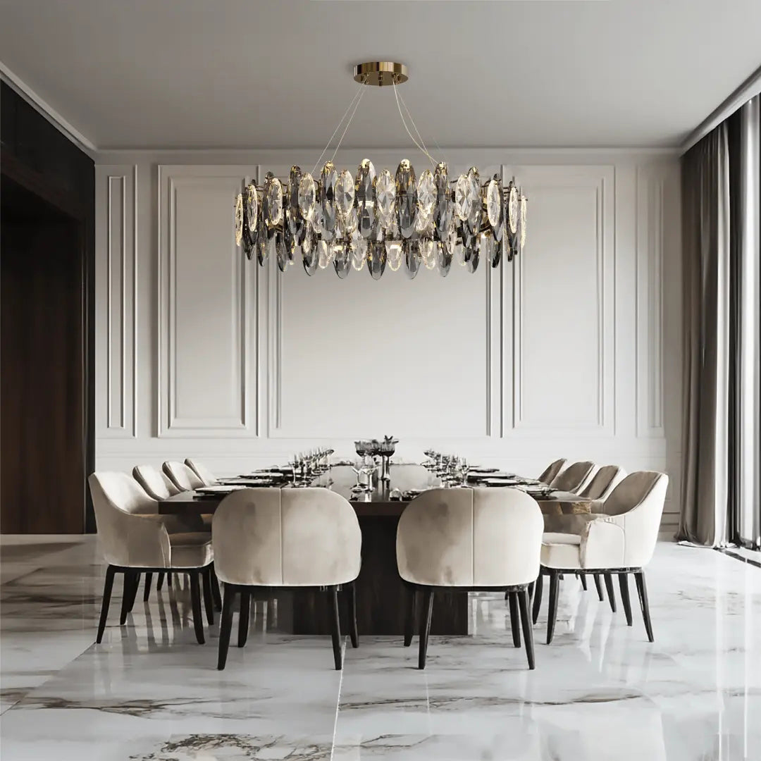 The Crescent black crystal chandelier is on display in the dining room, the crystal lighting is hanging above a modern dining table.