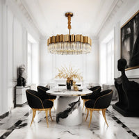 Hera gold crystal round chandelier in dinning room with black chairs.