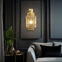 A Hestia crystal wall sconce on display  above sofa in living room.