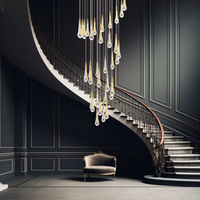 The Indura Staircase crystal lighting hangs in the center of the staircase in a modern decorative style