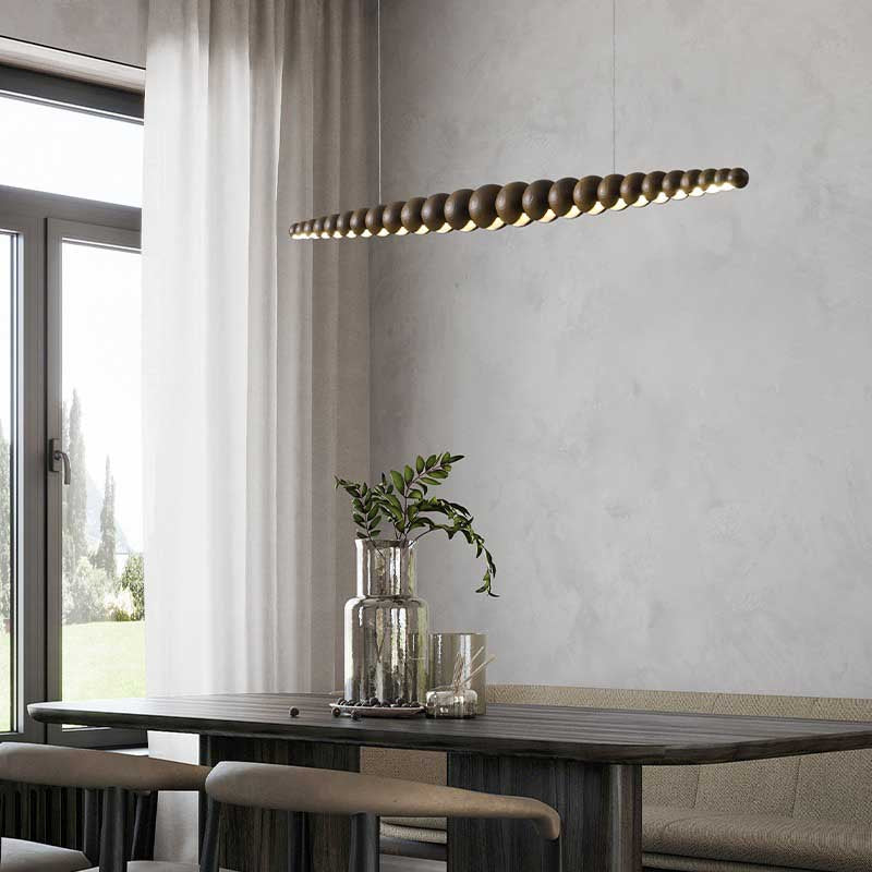 Side view of Nimbus brown wood chandelier above modern black style dining table.